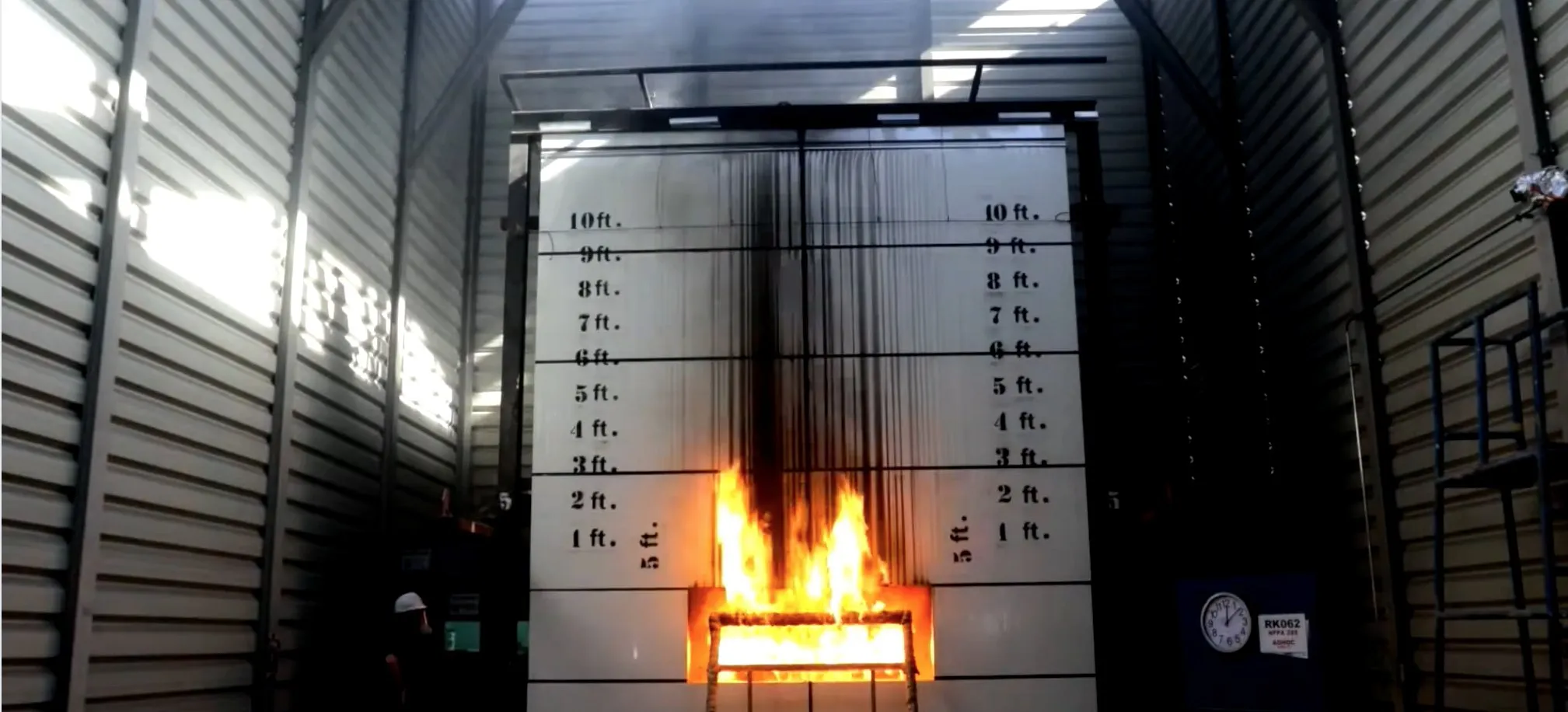 IKU Firetech under NFPA 285 test at Thomas Bell-Wright, Dubai: the burner alight below intact cladding panels